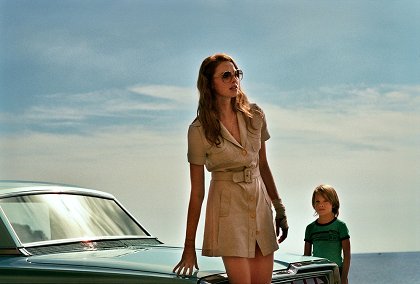 La Dame dans l'auto avec un fusil et des lunettes